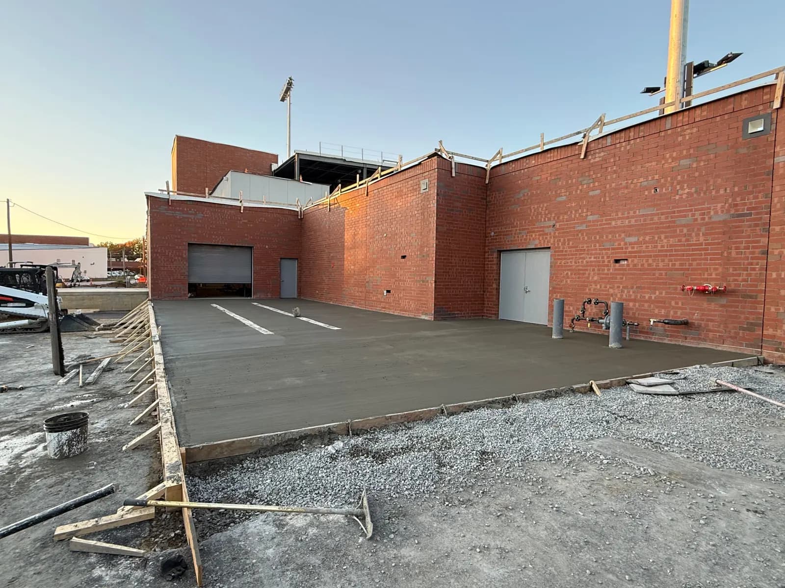 Finished commercial concrete slab behind a brick building