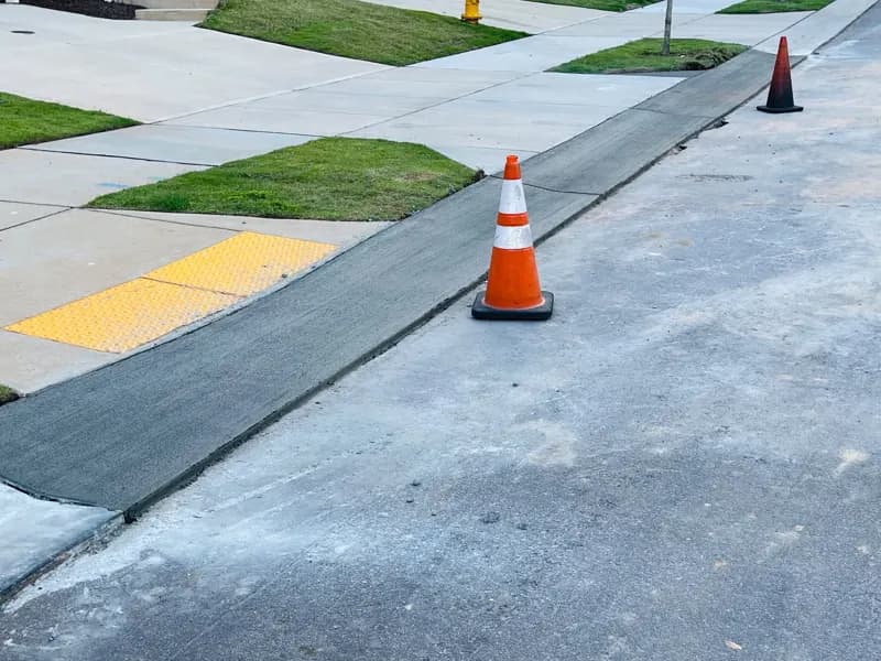 Replaced section of concrete at a curb and sidewalk